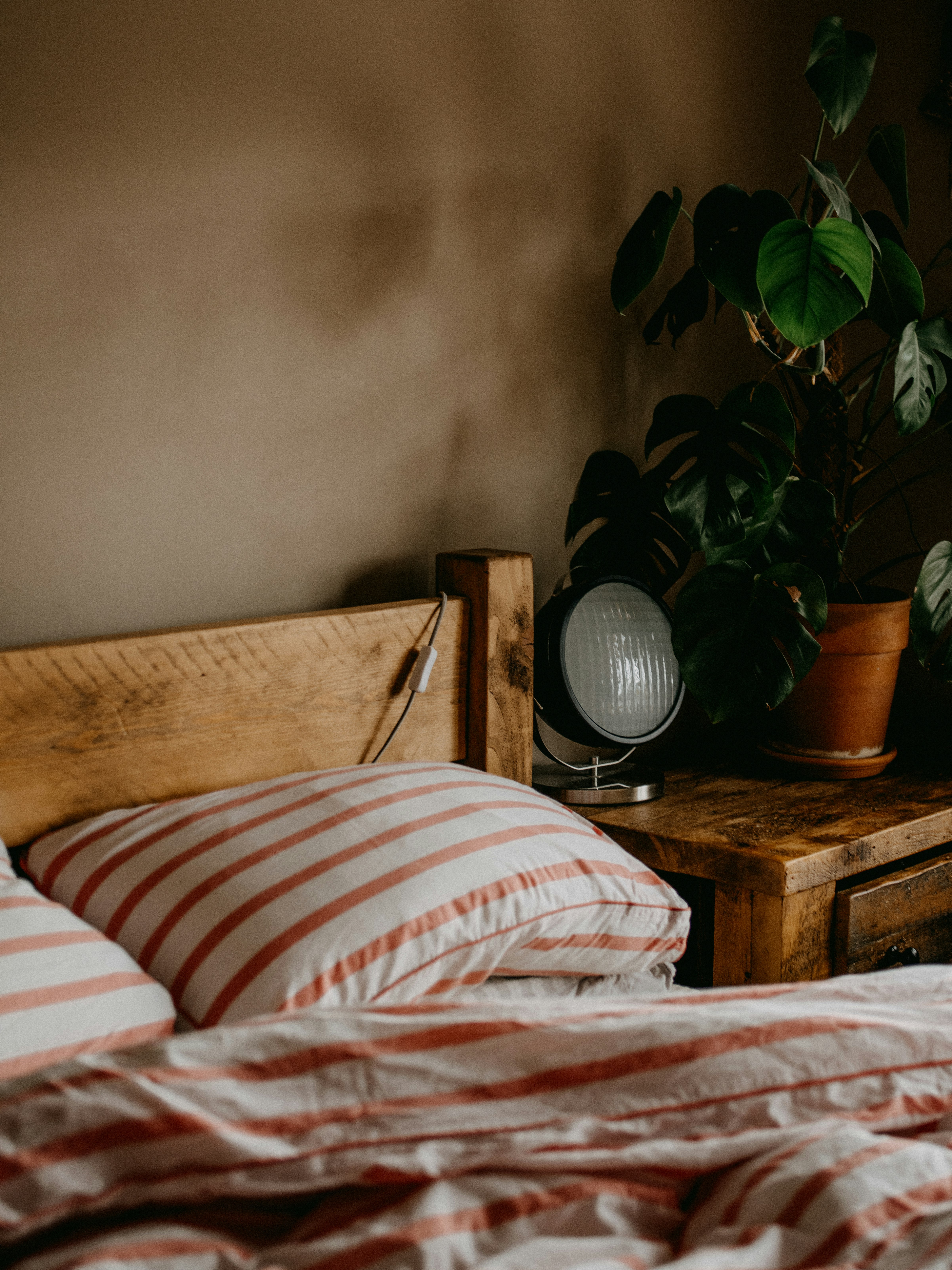 white and red striped pillow on bed